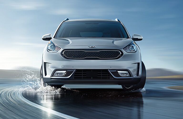 Front view of 2018 Kia Niro driving on wet road