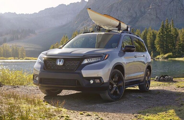 Silver 2019 Honda Passport Next to a River with a Kayak on the Roof