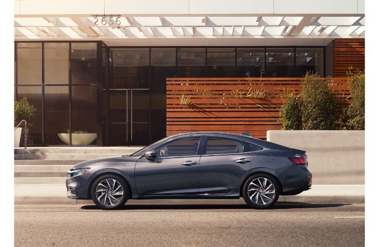 2021 Honda Insight exterior side shot with Modern Steel Metallic paint color parked outside a fancy home