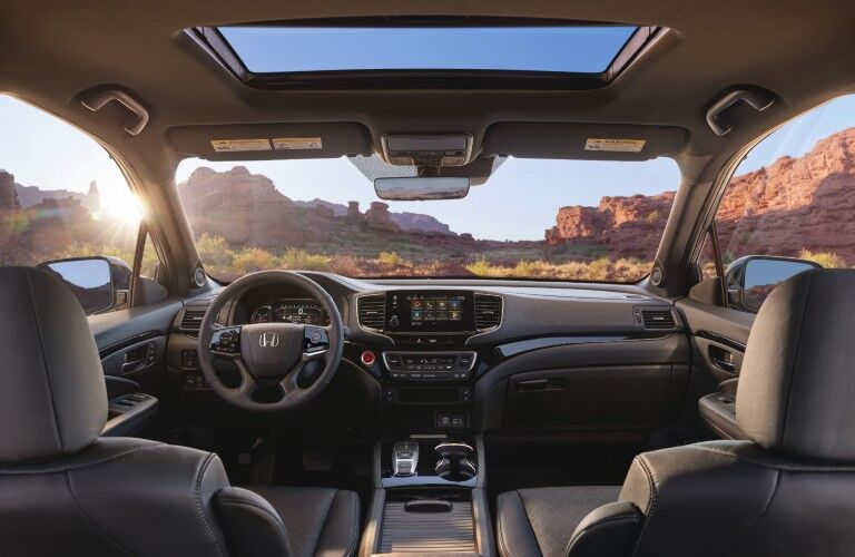 2021 Honda Passport interior shot of front seating, steering wheel, moonroof, and dashboard