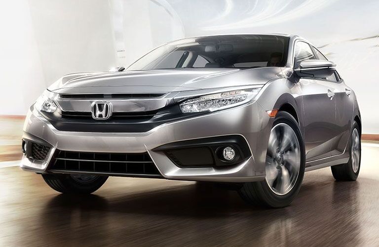 2018 Honda Civic Sedan driving up a bright ramp