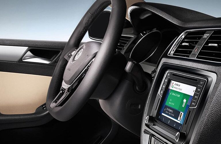 Close up shot of the steering wheel and touch screen inside the 2018 Volkswagen Jetta