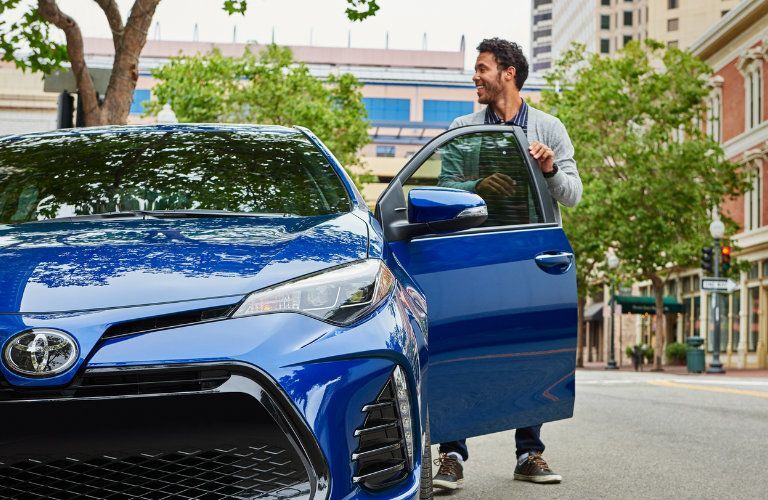 man getting inside a 2019 Toyota Corolla