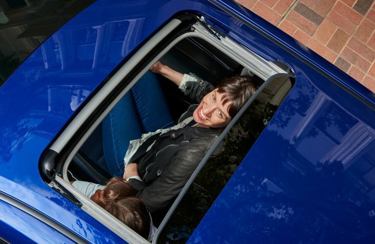 overhead view of woman looking inside the 2019 Toyota Corolla