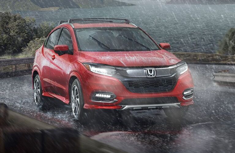 Red 2019 Honda HR-V driving through a downpour