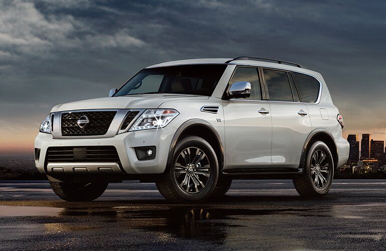 2018 Nissan Armada parked in empty lot with a city in the background