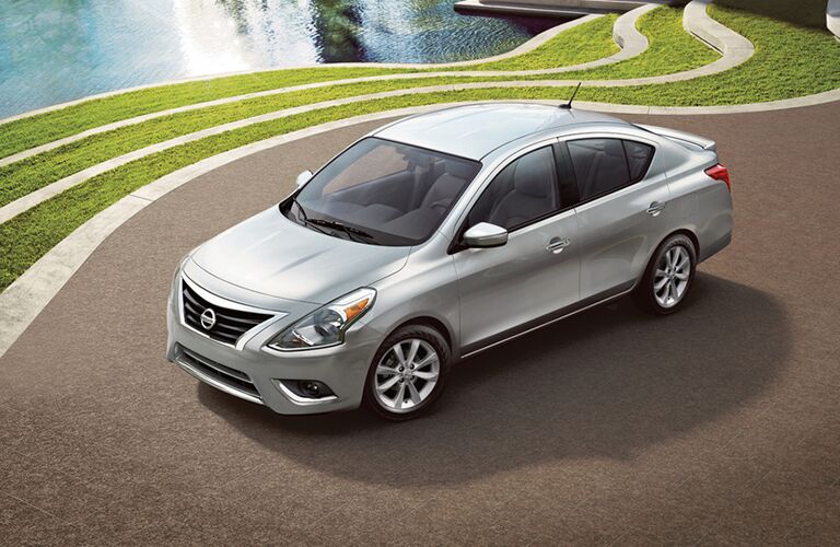 2018 Nissan Versa Sedan parked by a decorative pond