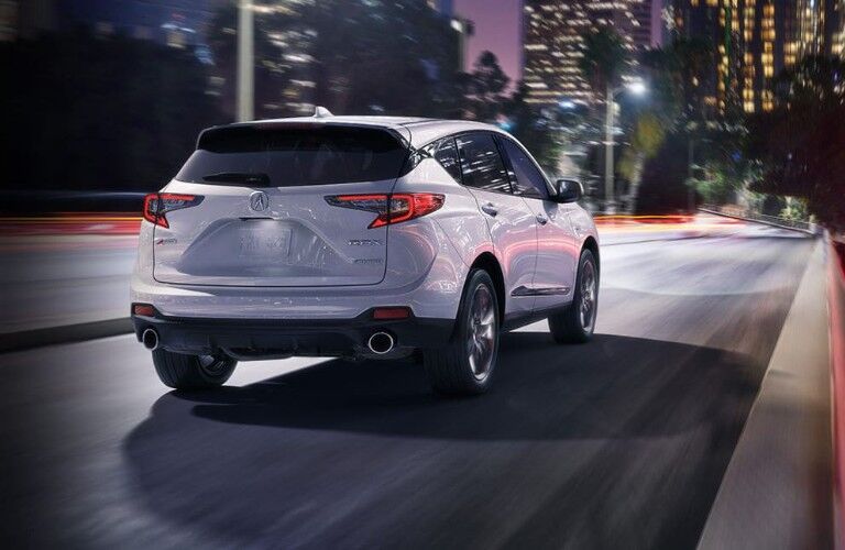 White 2020 Acura RDX with a city skyline in the background