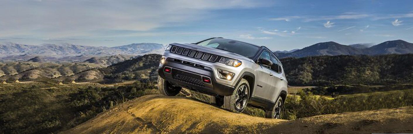 Jeep Compass driving on mountainous terrain
