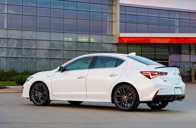 White 2020 Acura ILX parked near a building with large glass windows
