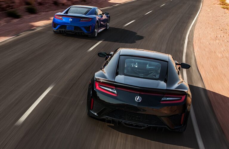 Rear view of blue 2020 Acura NSX and black 2020 Acura NSX