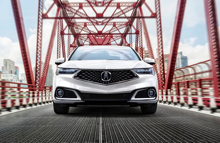 White 2020 Acura TLX driving across a bridge
