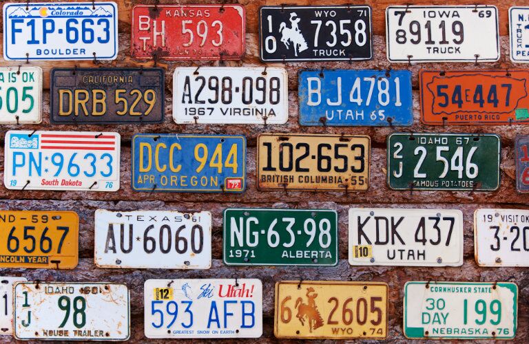 license plates from different states posted on wall