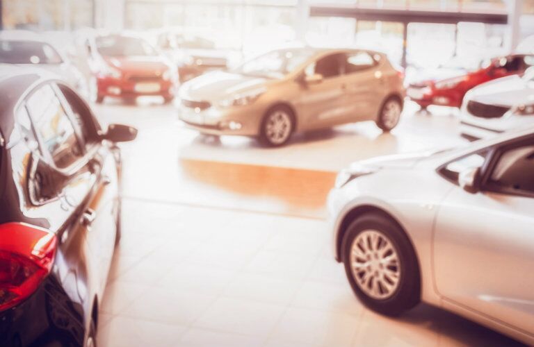 selection_of_small_cars_parked_in_dealership_showroom