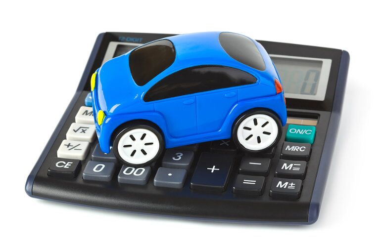 toy_blue_car_on_top_of_a_calculator