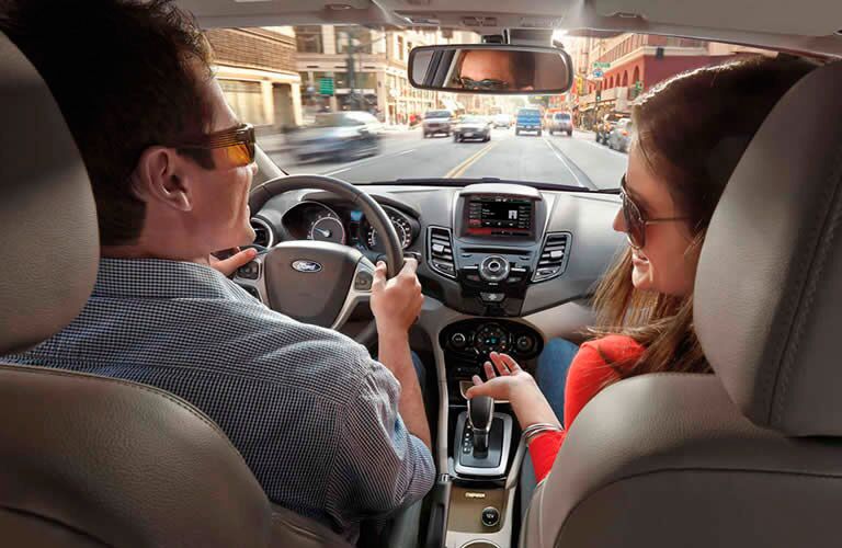 Couple driving down road.