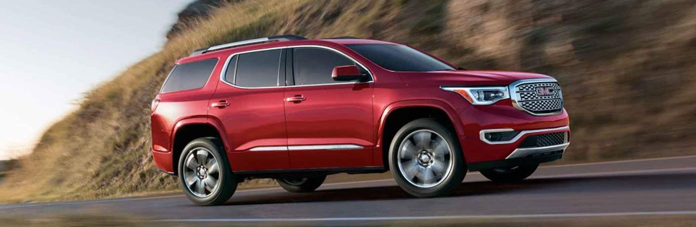 2017 GMC Acadia driving up a hill by a mountain