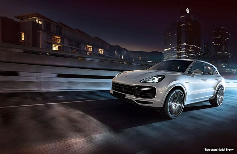 white 2020 porsche cayenne driving at night in merriam kansas