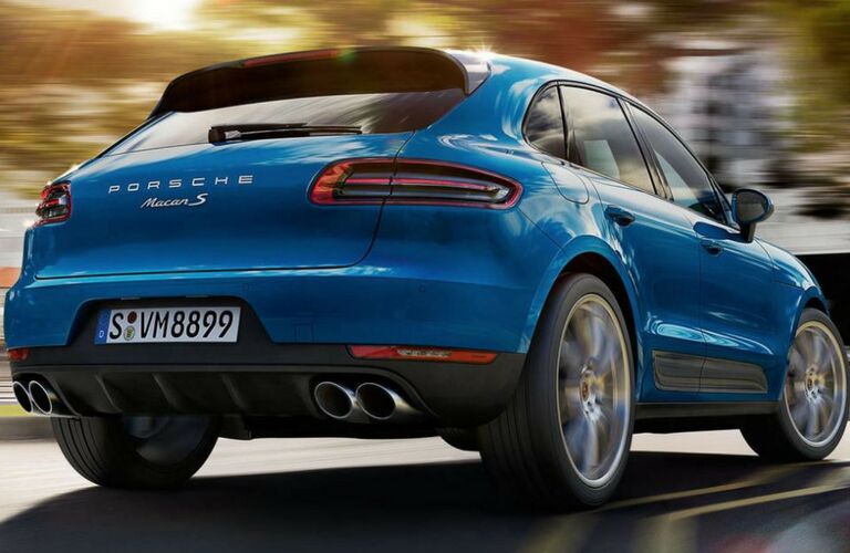 2018 Porsche Macan driving on road rear view.