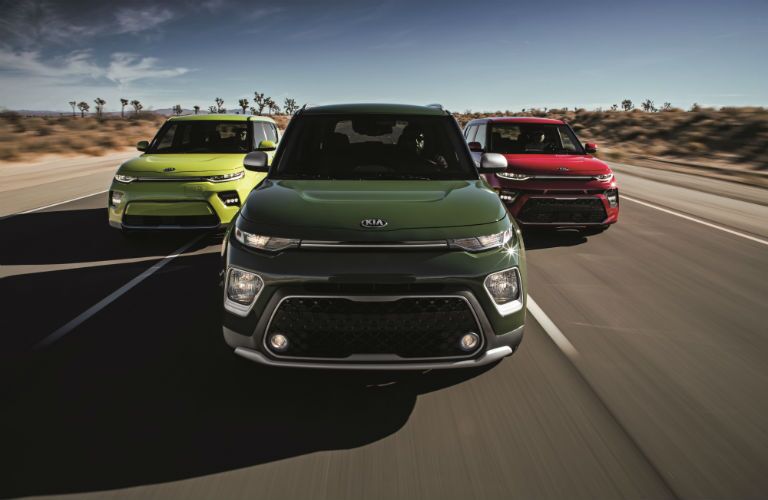 A photo of thee models of the 2020 Kia Soul on the road.