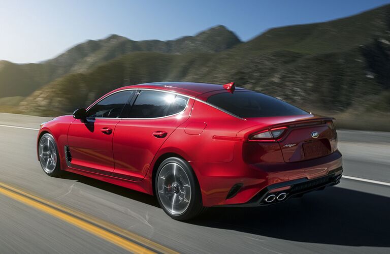 A left profile photo of the Kia Stinger in motion on the road.