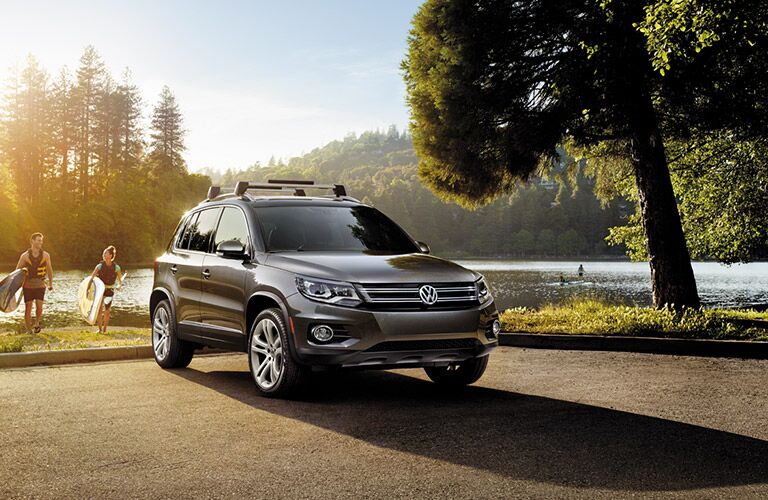 2016 Volkswagen Tiguan parked by a lake as the sun sets.