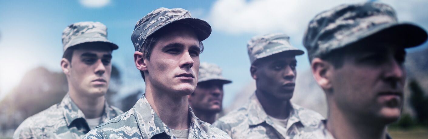 Several soldiers stand at attention with grim, determined looks on their faces.