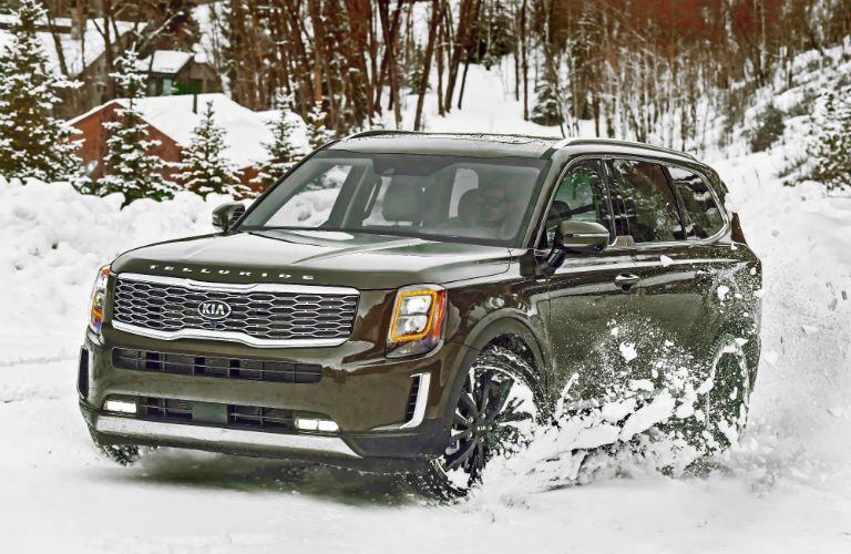 A photo of the 2020 Kia Telluride driving through the snow.