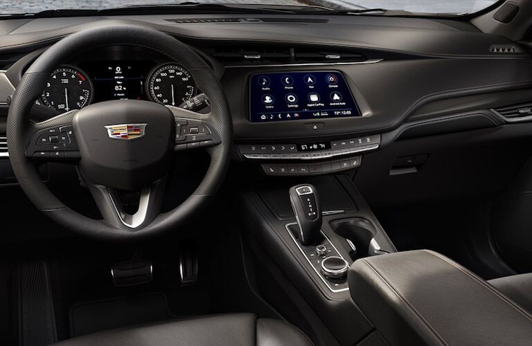 2019 Cadillac XT4 interior shot of steering wheel, transmission, and dashboard layout with infotainment screen