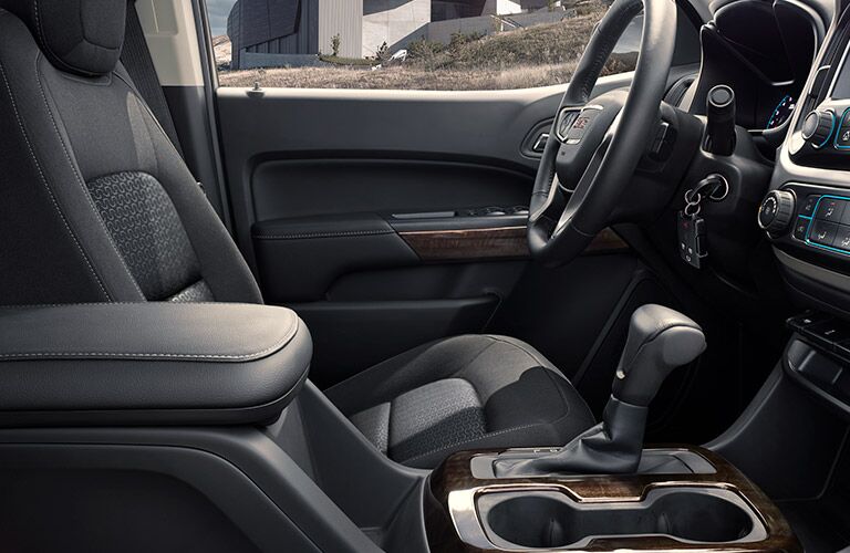 2019 GMC Canyon interior side shot of driver's seat, steering wheel, and transmission