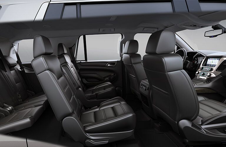 2019 GMC Yukon Denali interior side shot of three-row seating and black leather upholstery