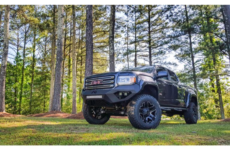 2019 GMC Canyon SCA performance truck exterior shot parked on grass in a forest surrounded by sparse green trees