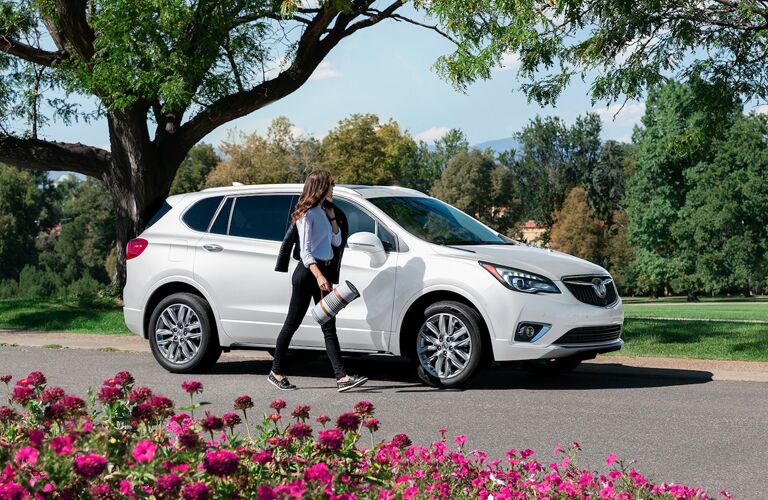 White 2020 Buick Envision near a garden