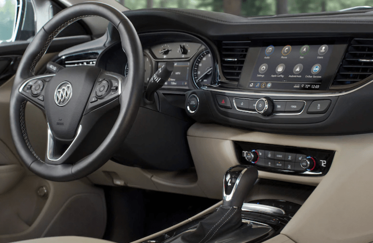 2020 Buick Regal TourX interior shot of steering wheel, dashboard, and transmission