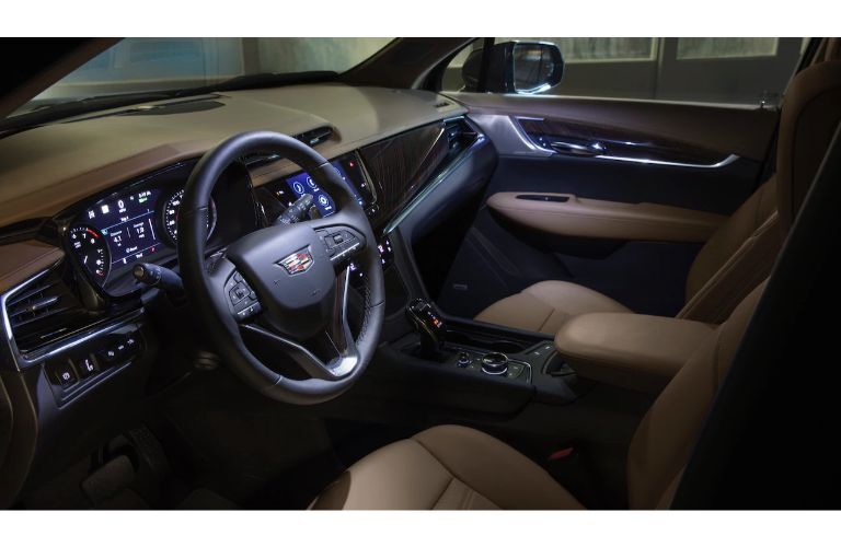 2020 Cadillac XT6 SUV interior shot of front seating, steering wheel, and dashboard design and accents