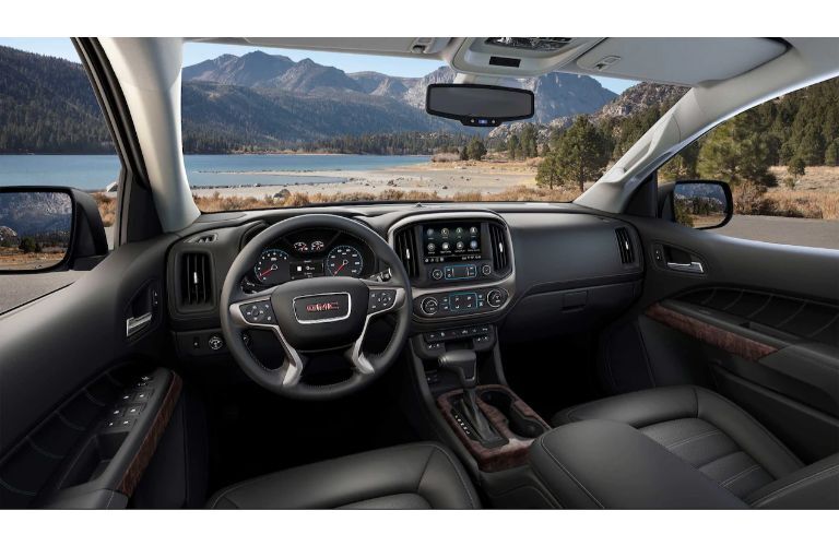 2021 GMC Canyon interior shot of front seating, steering wheel, and dashboard