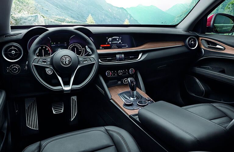 front interior of 2019 alfa romeo stelvio including steering wheel and infotainment system