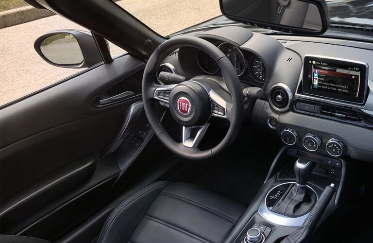 front interior of 2019 fiat 124 spider including steering wheel and infotainment system