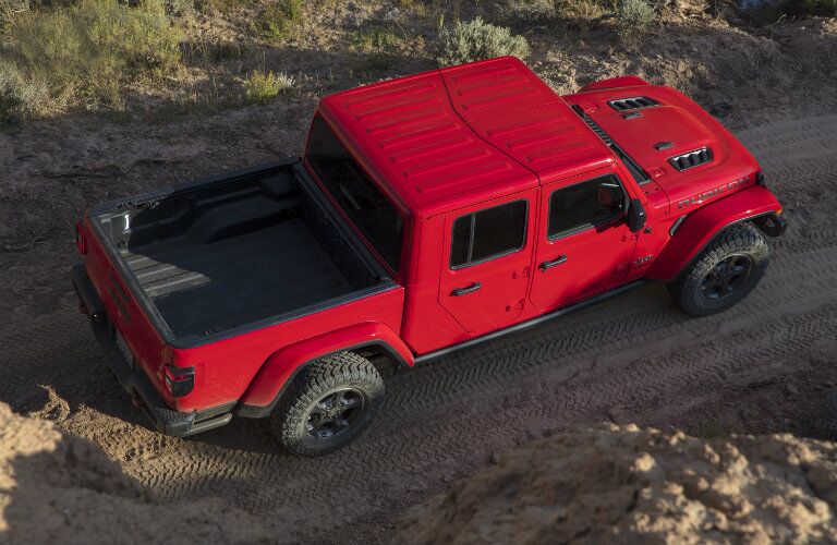 2020 Jeep Gladiator exterior overhead shot with red paint color driving on a dirt road