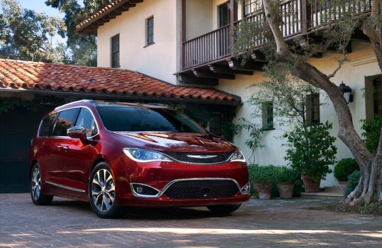 Red 2020 Chrysler Pacifica parked in front of modern-styled house