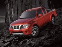 Exterior view of a red 2017 Nissan Frontier parked on a rocky hill