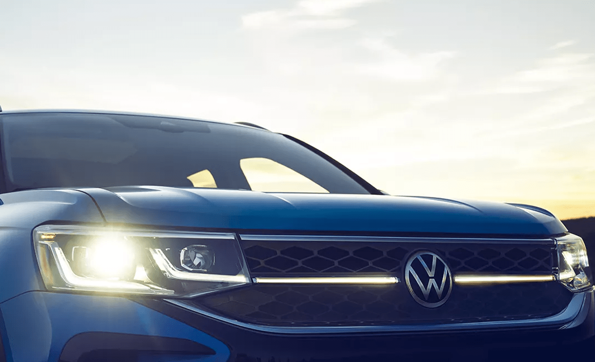 The front grille of a VW Taos at sunset.