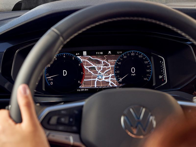 A female driver with her hands on a Taos steering wheel.