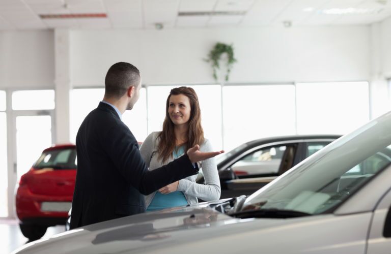A stock photo of a sales person helping a customer.